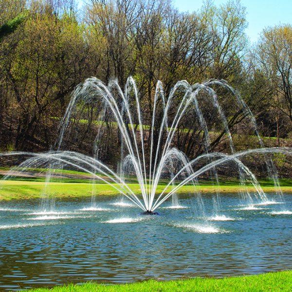 Kasco J-Series decorative pond fountain creating an elegant water spray display in a landscaped pond.